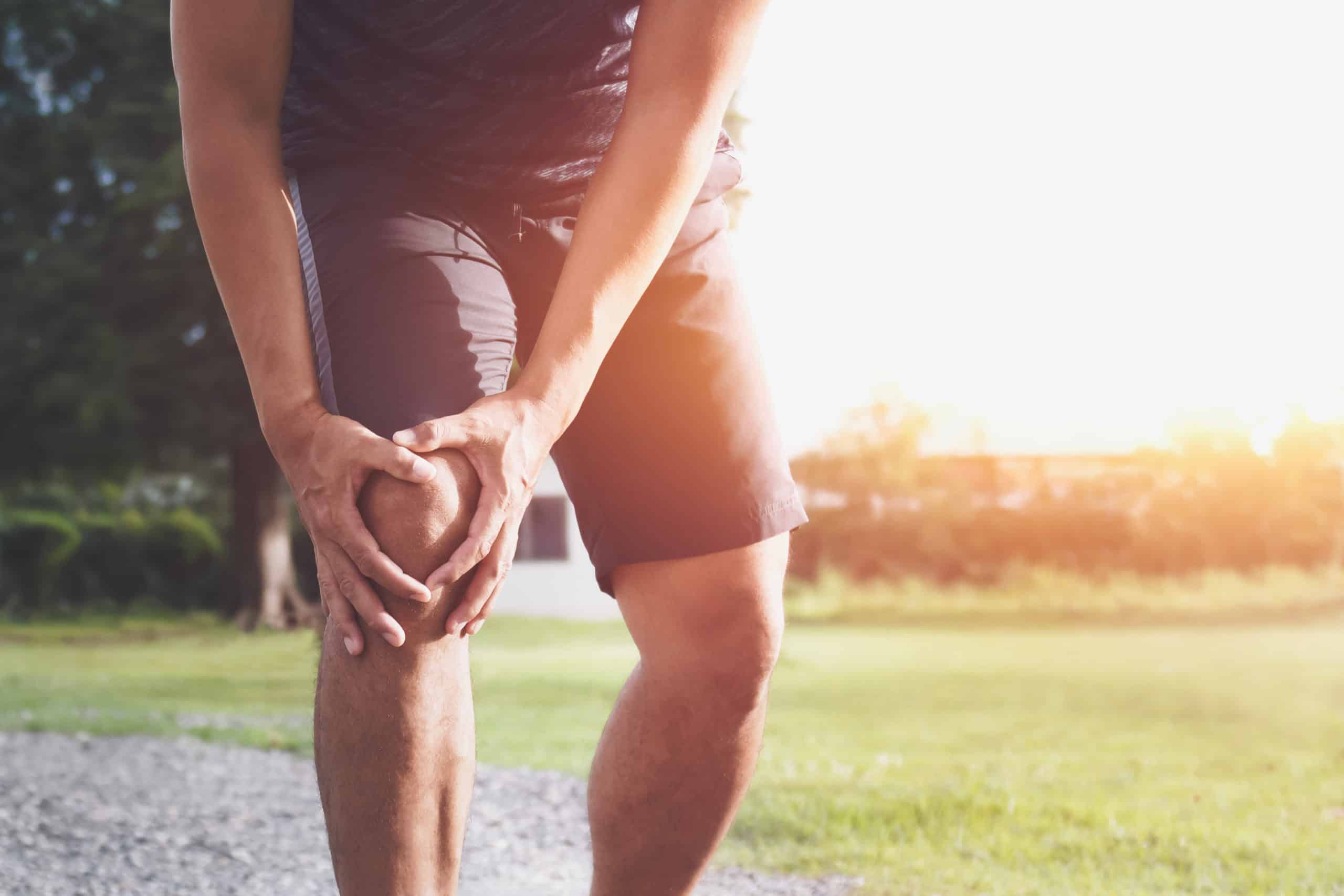 runner sport with running knee injury at park